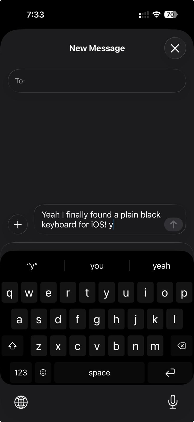 Black Keyboard on an iPhone in Messages: a draft reading Yeah I finally found a plain black keyboard for iOS, above a suggestion strip and a pure black QWERTY keyboard with white letters, an emoji key, a space bar labelled space, and a return key.