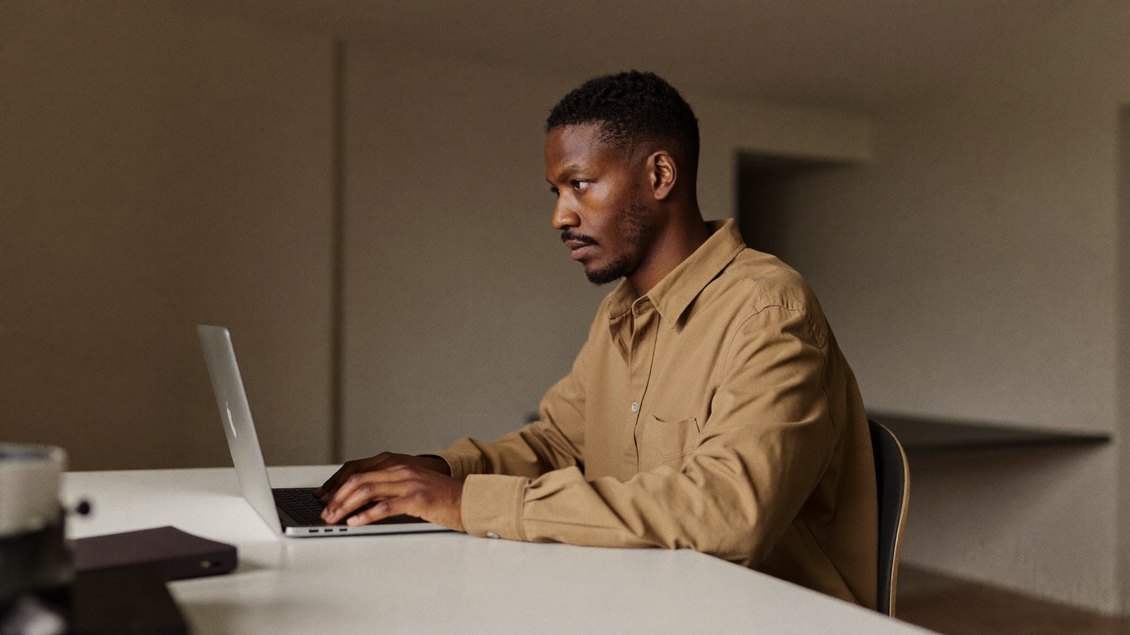 A small-business owner uses a laptop for focused, repetitive work